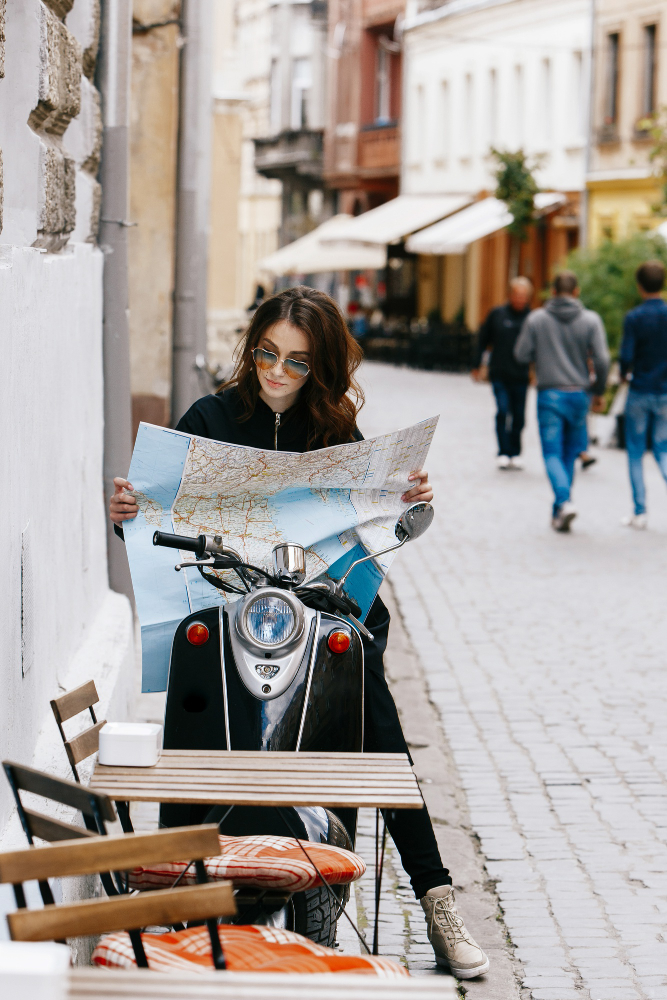 woman-original-sunglasses-sits-scooter-with-touristic-map